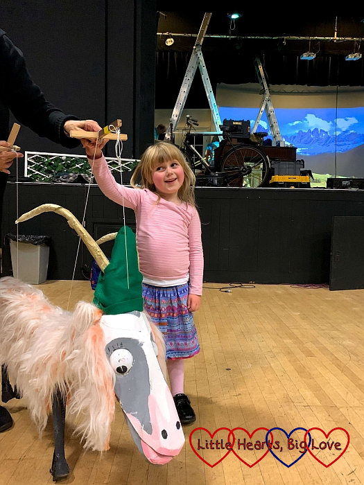 Sophie standing in front of the stage with one of the goats from the Lonely Goatherd scene