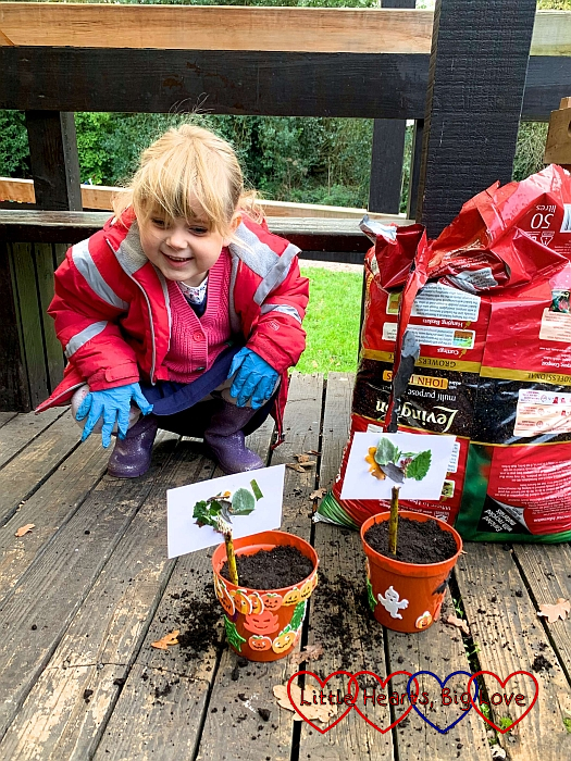 Sophie with her decorated pots containing spring bulbs