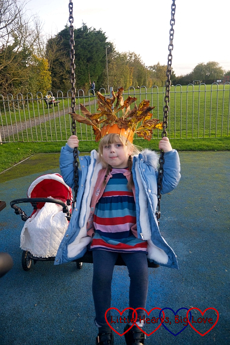 Sophie on the swing wearing her autumn crown