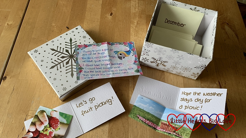 A box of envelopes labelled for each month with notecards showing family time ideas