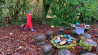 Sophie exploring the fairy garden at Coombe Mill