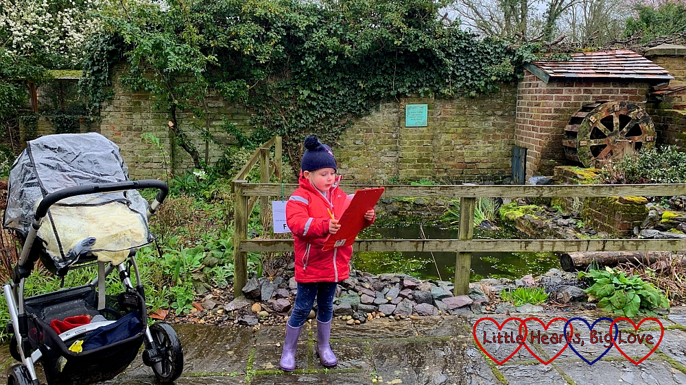 Sophie looking at her Beautiful Birds trail by the water wheel at Iver Environment Centre