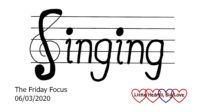 The word 'singing' written on a musical stave with the 'S' forming part of a treble clef