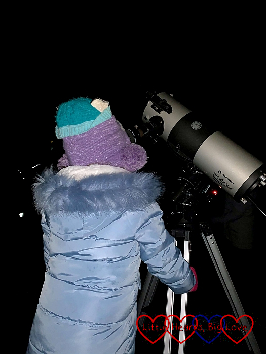 Sophie looking through a telescope