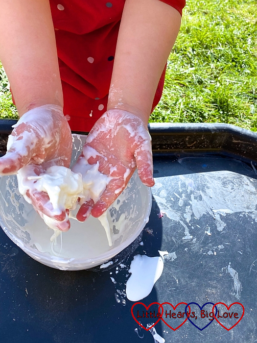 Sophie squishing the oobleck into a ball