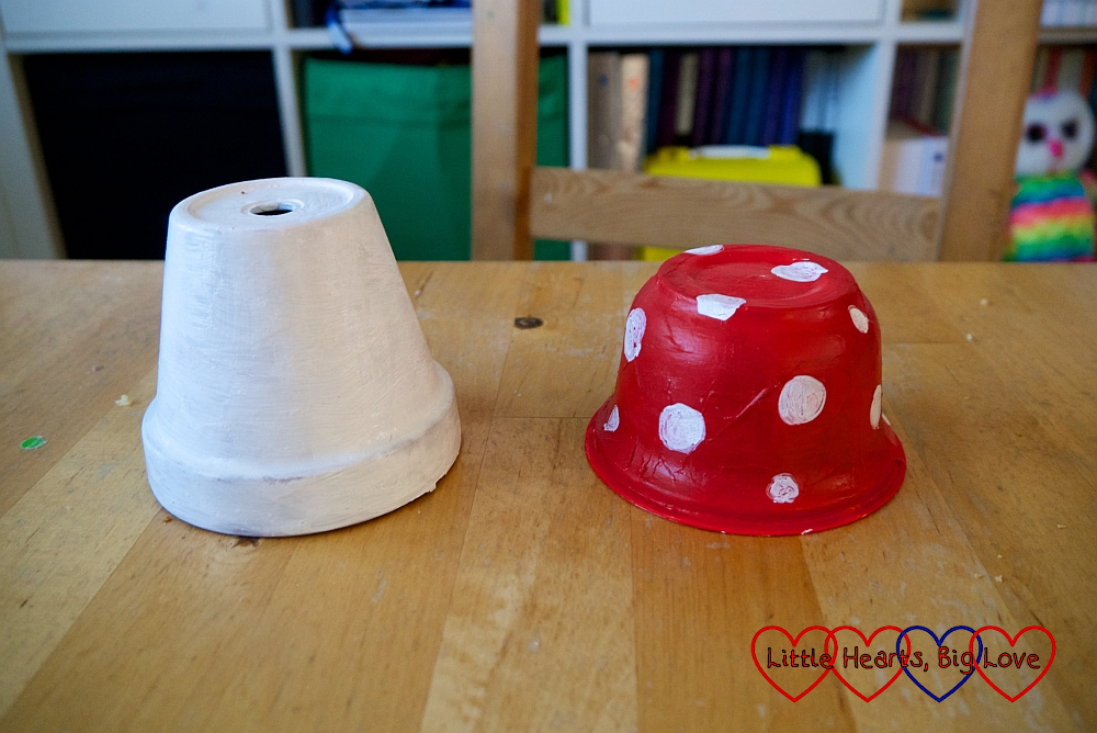 A plant pot painted white and a yogurt pot painted red with white spots