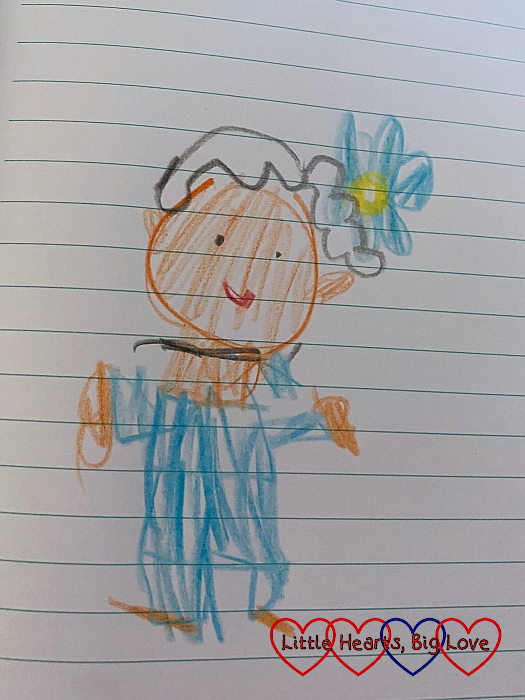 Sophie's drawing of Nanny in a blue outfit with a blue flower in her hair