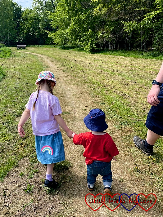 Sophie holding Thomas's hand while out for a walk