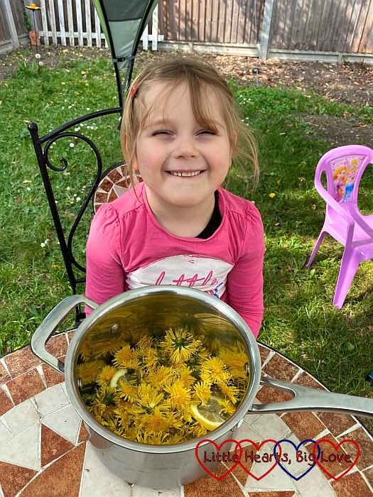 Sophie with a pan full of dandelion flowerheads