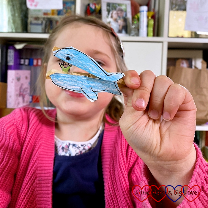 Sophie holding her peg whale with Jonah inside the whale's mouth