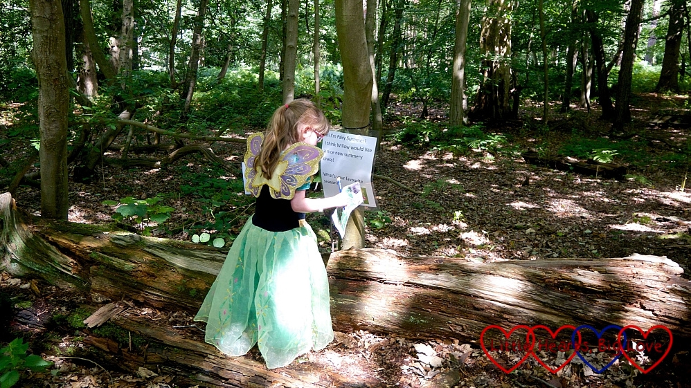 Jessica wearing a fairy costume in the woods, facing away from the camera