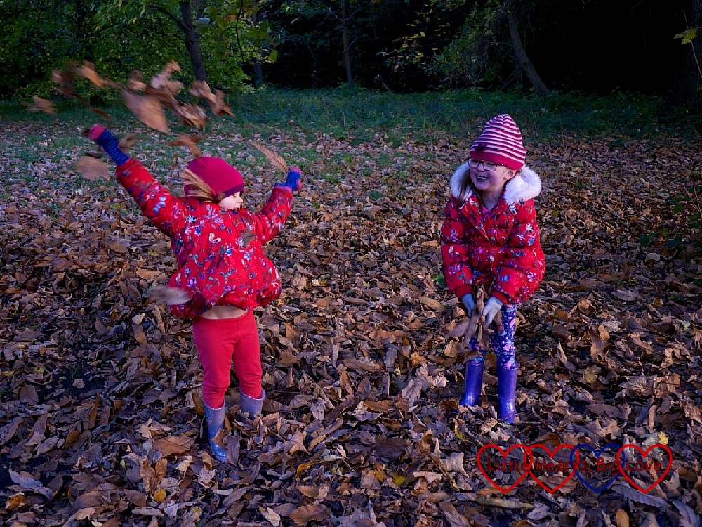 Jessica laughing at Sophie throwing autumn leaves into the air