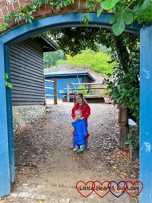 Sophie and Thomas standing in the doorway leading out of the walled garden