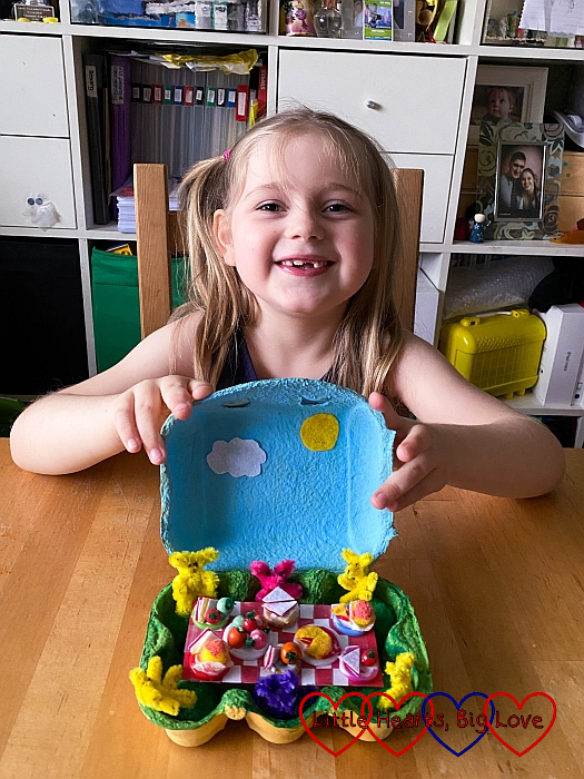 Sophie with her teddy bears' picnic in an eggbox