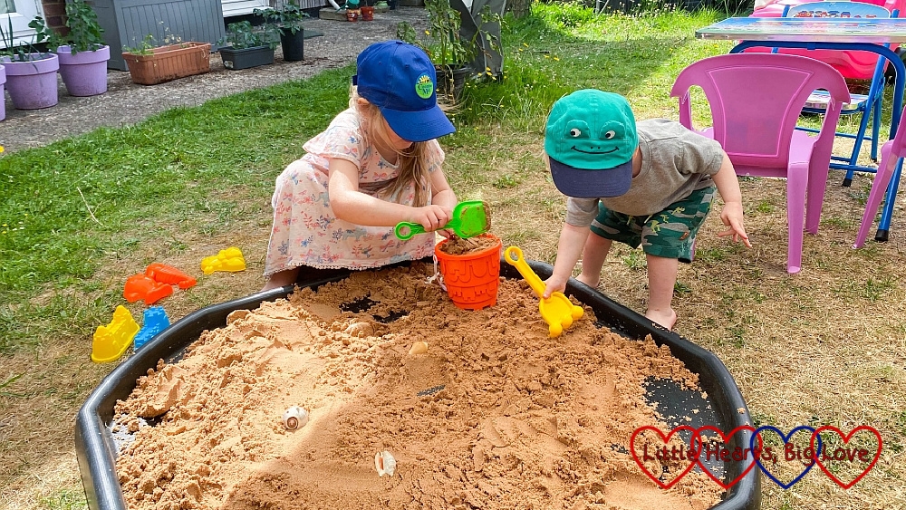 Thomas and Sophie playing with sand in the tuff tray