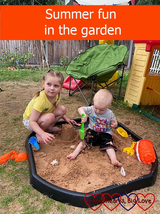 Thomas and Sophie playing with sand in the tuff tray - "Summer fun in the garden"