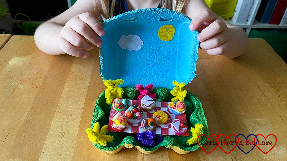A teddy bears' picnic scene in an egg box