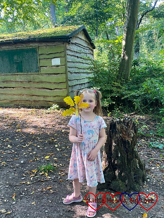 Sophie with a "fairy wand" made from a stick with leaves attached