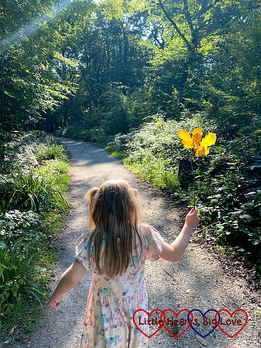 Sophie walking through the wood with her nature "fairy wand"
