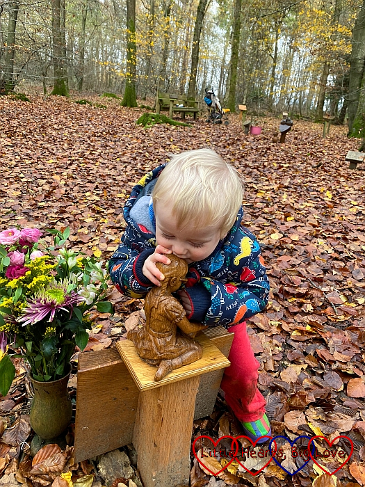 Thomas kissing the wooden carving of Jessica at her forever bed