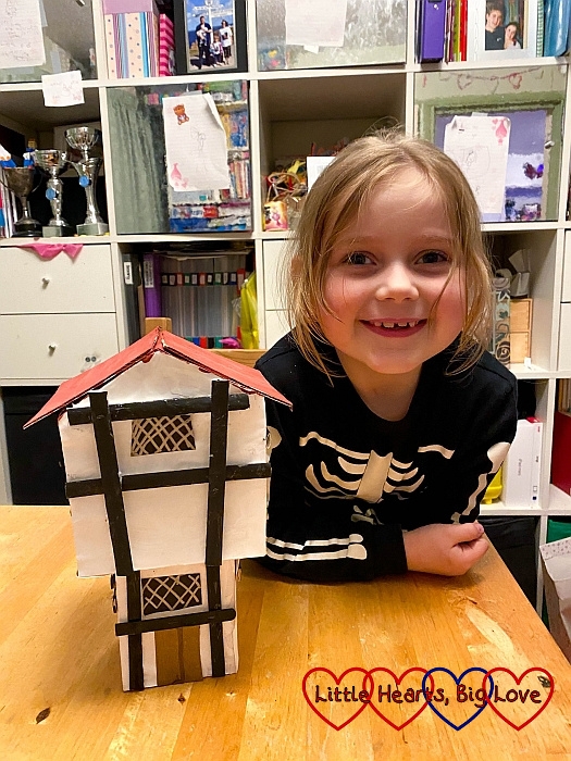 Sophie with her finished Great Fire of London house