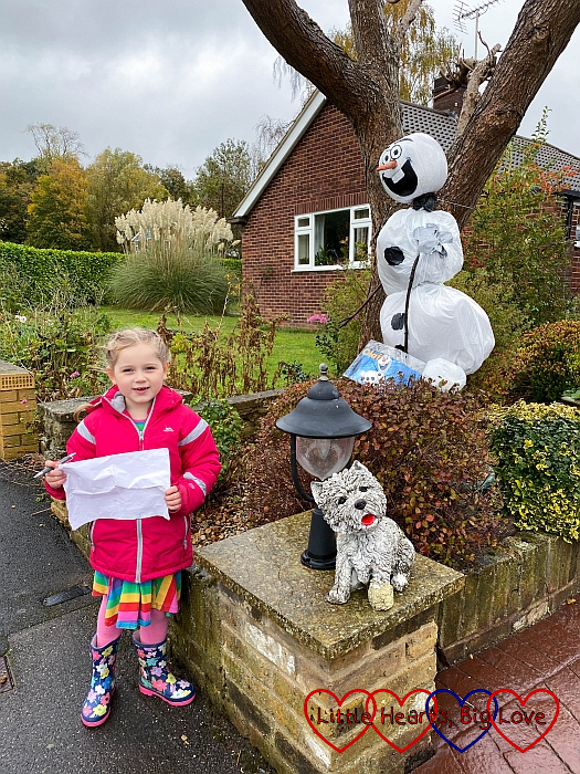 Sophie with an Olaf-themed scarecrow