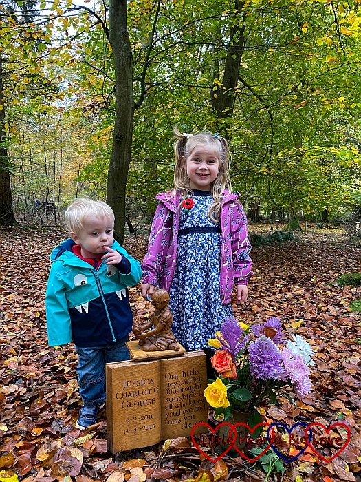 Sophie and Thomas with the carving of Jessica at Jessica's forever bed