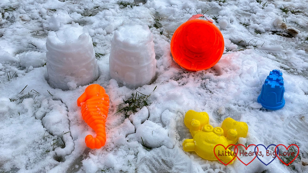 A bucket and sand toys on the snow