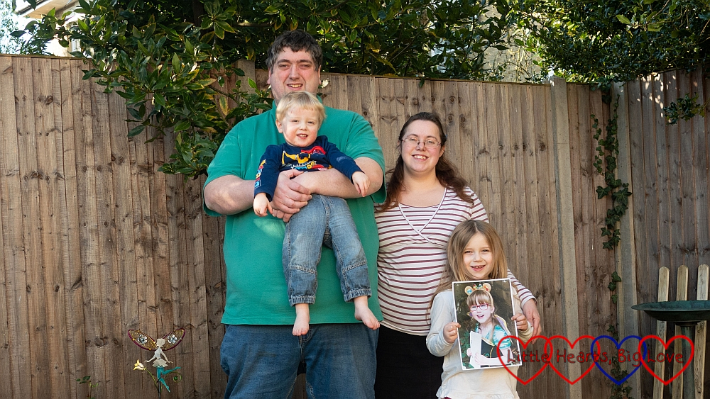 My husband (holding Thomas), me and Sophie (holding Jessica's picture) out in the garden