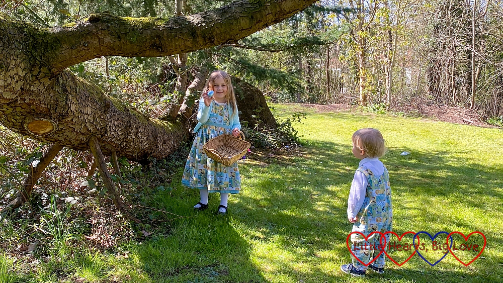 Sophie finding Easter eggs in Grandma's garden with Thomas looking on