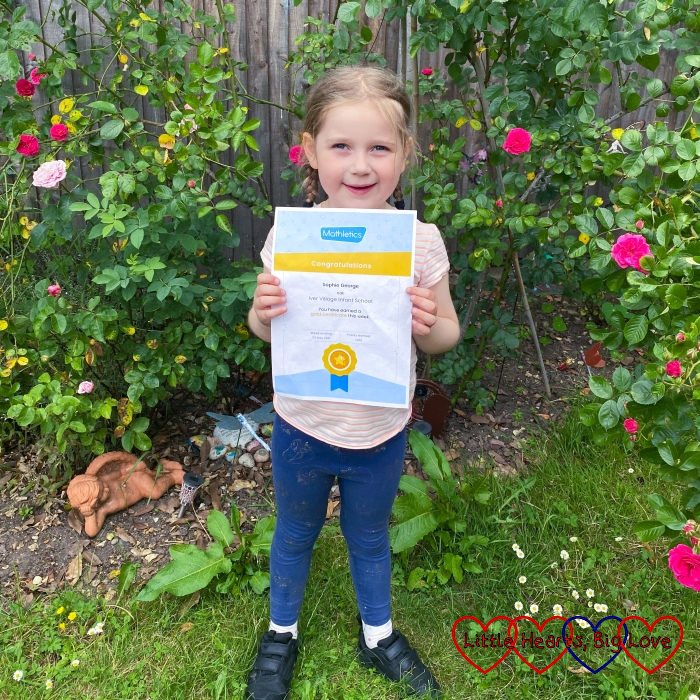Sophie holding her gold Mathletics certificate