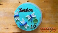 Jessica's birthday cake - a round cake iced with aqua buttercream with three fondant dragonflies, a green fondant lilypad and the words "Jessica" and "10" in chocolate writing