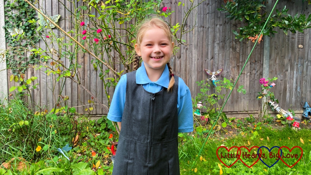 Sophie standing in her school uniform in the garden