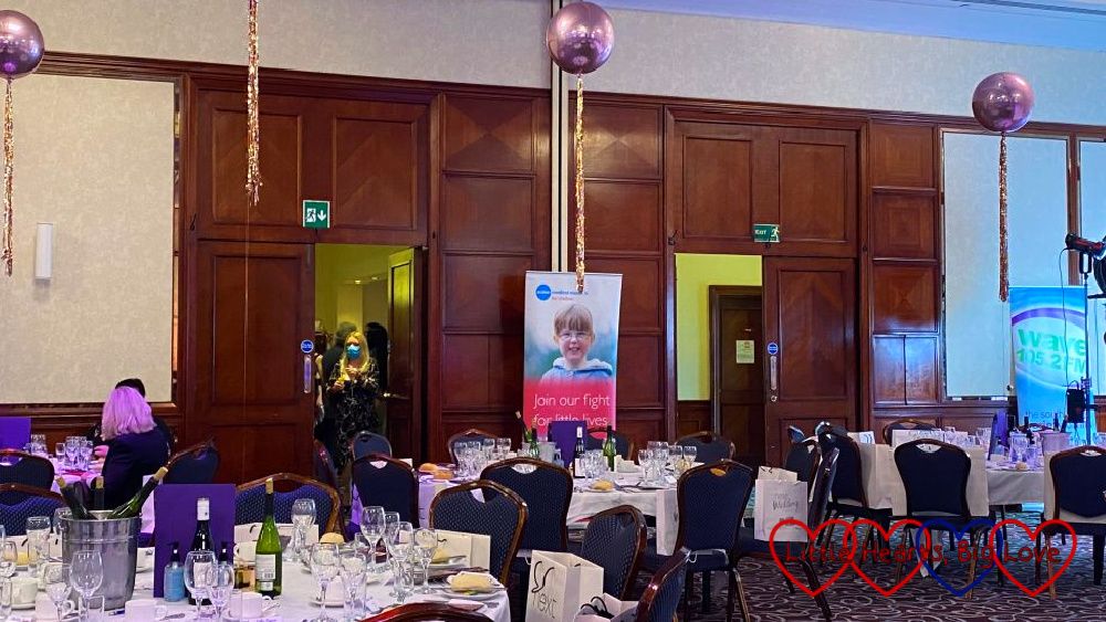 Jessica's banner in the background of tables and chairs set up for the Dine with Davina event