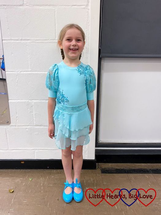 Sophie in an aqua leotard and skirt and wearing blue tap shoes