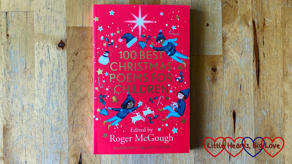 A copy of '100 Best Christmas Poems for Children' on a wooden table
