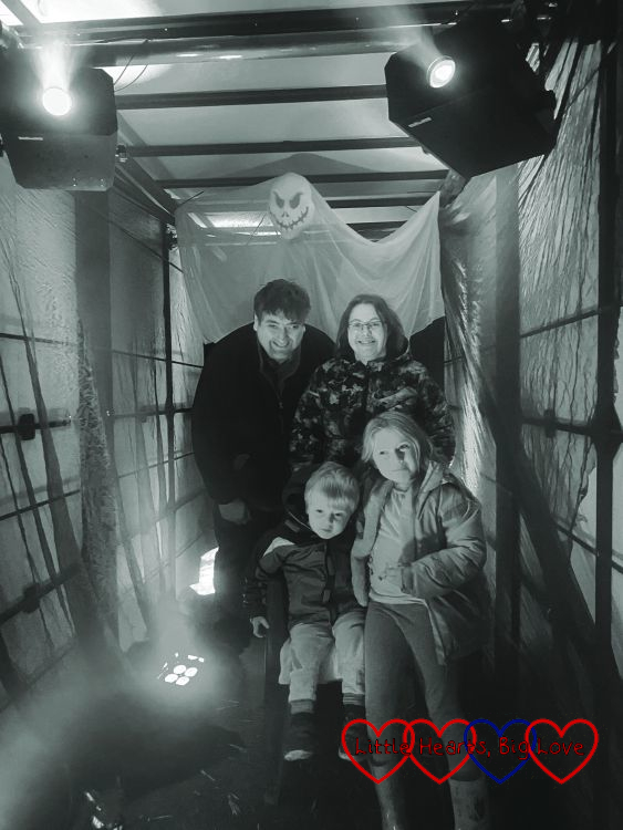 A black and white photo of me, my husband, Thomas and Sophie in a Halloween themed trailer