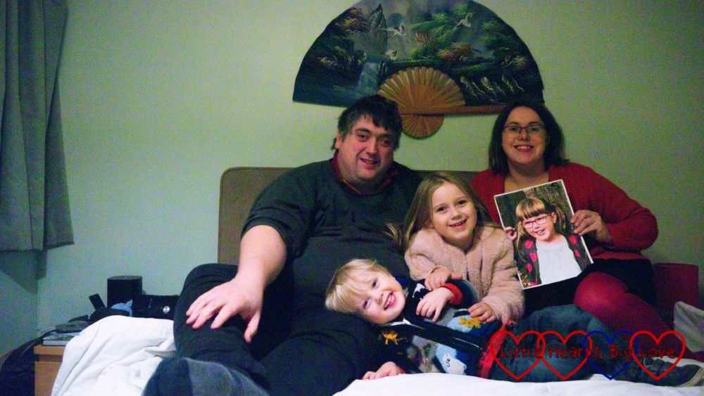 Me (holding a photo of Jessica), Thomas, Sophie and Daddy sitting on our bed