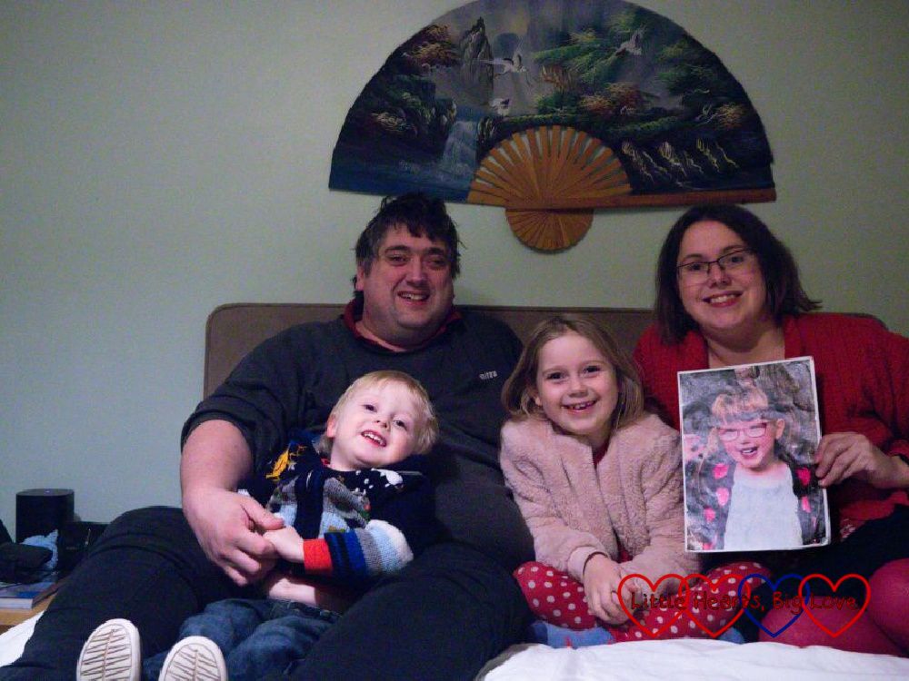 Me (holding a photo of Jessica), Thomas, Sophie and Daddy sitting on our bed