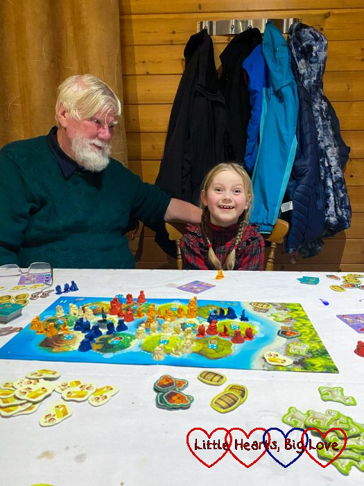 Sophie with her grandad playing Catan Junior