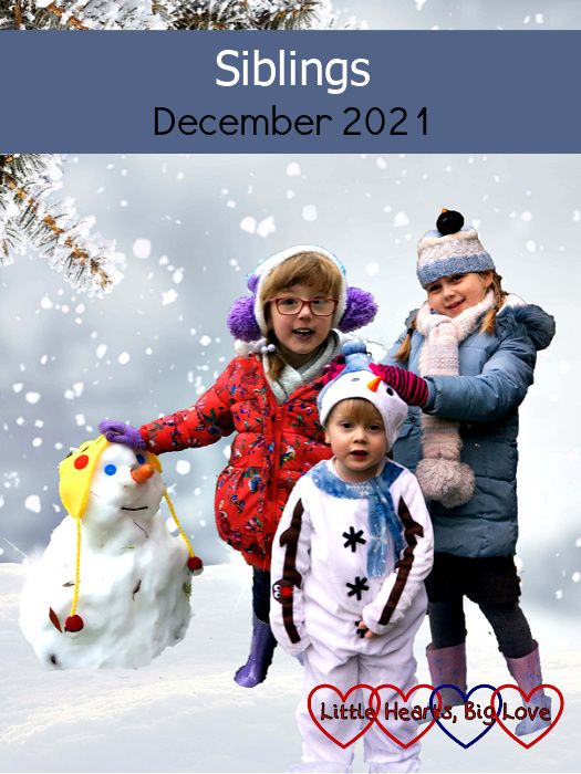 Jessica standing next to a snowman with Sophie standing behind Thomas (dressed as a snowman) against a snowy backdrop - "Siblings - December 2021"