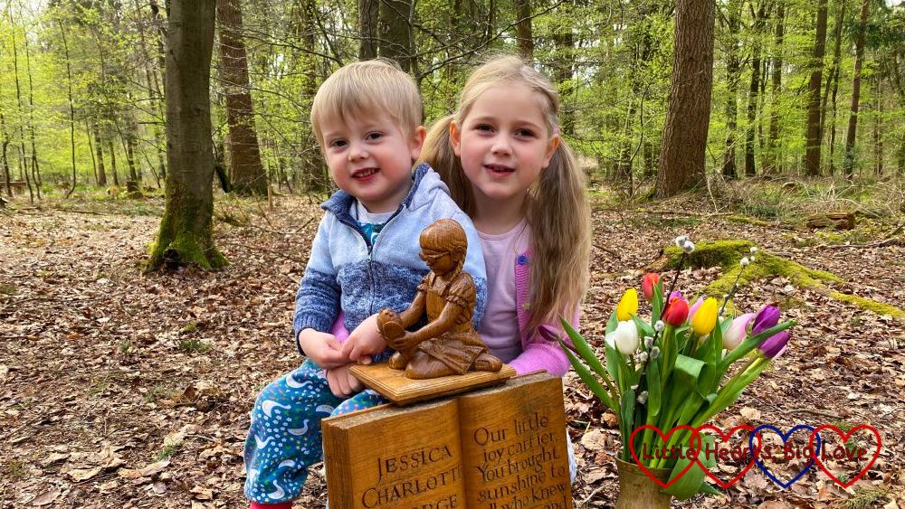 Sophie and Thomas with the wooden sculpture of Jessica at Jessica's forever bed