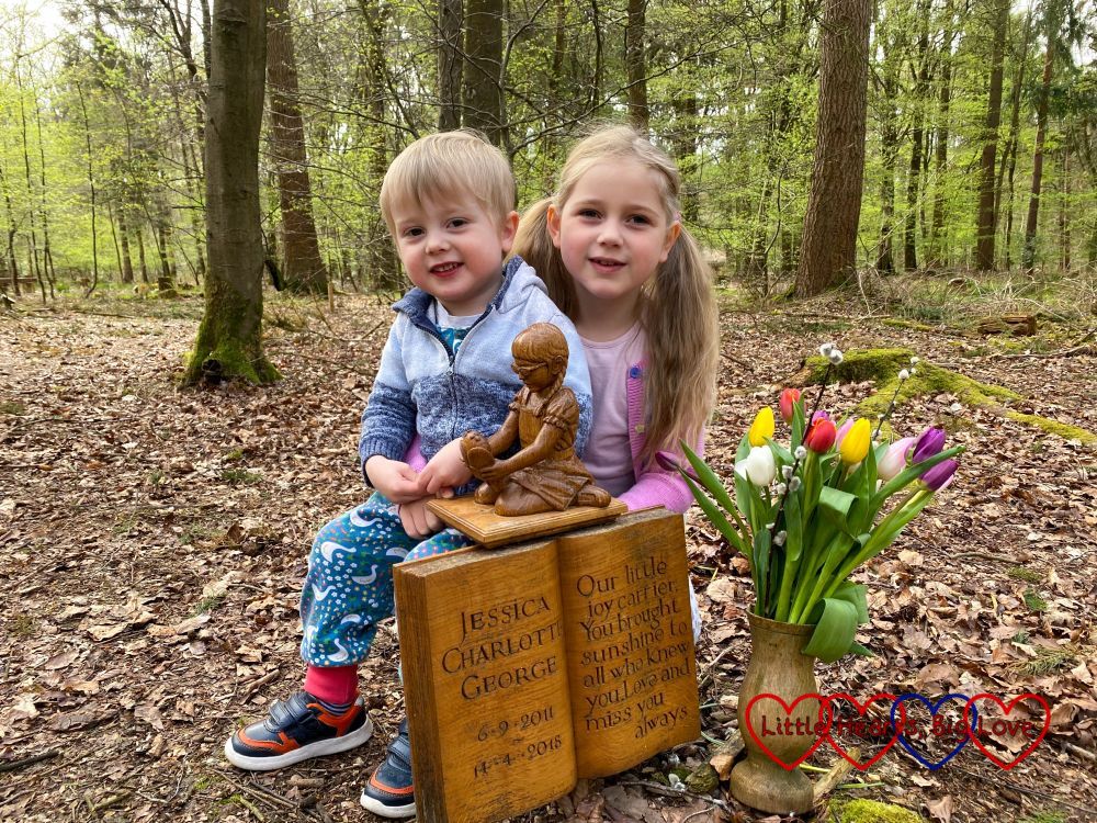 Sophie and Thomas with the wooden sculpture of Jessica at Jessica's forever bed