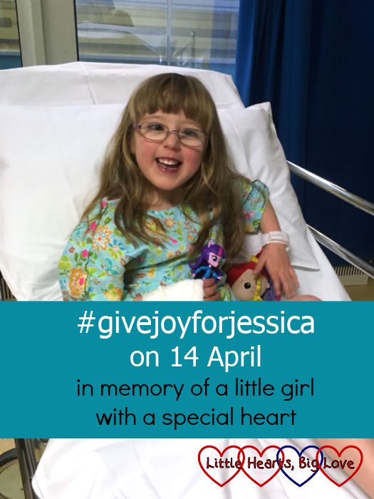 A very smile Jessica sitting on a theatre trolley about to go for her last heart surgery