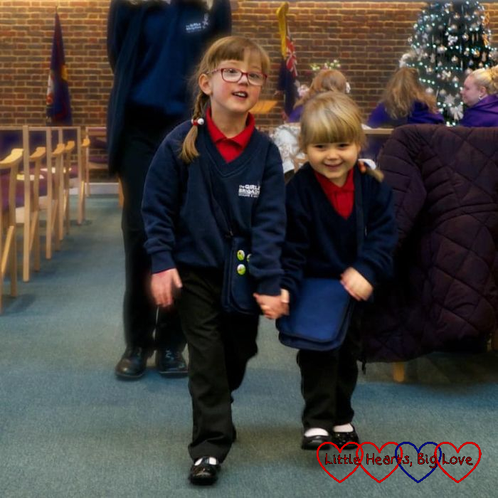 Jessica and Sophie in their Girls' Brigade uniforms at church parade in December 2017, holding hands walking up the aisle out of church