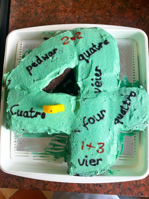A cake with the word 'four' in Welsh, French, Italian, Spanish, German and Luxembourgish