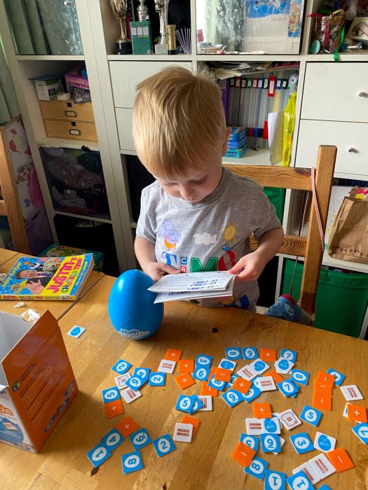 Thomas playing with his Maths Scramble game