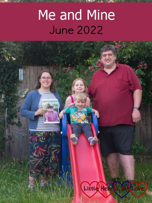 Me (holding a photo of Jessica) with Sophie standing at the top of a slide, Thomas sitting on the top of the slide and my husband standing next to the slide - "Me and Mine - June 2022"