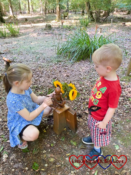Sophie and Thomas putting sticks on Jessica's memorial at her forever bed