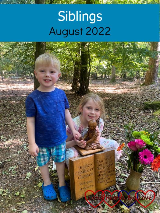 Thomas standing next to the wooden carving of Jessica at her forever bed with Sophie hugging Jessica's carving - "Siblings - August 2022"
